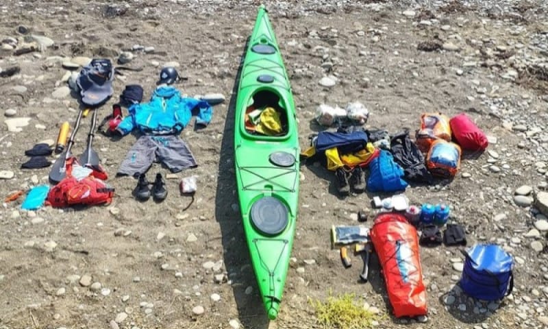 Green inflatable kayak and stuff around it