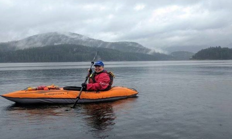 A woman is kayaking in the river